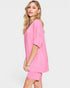 Woman wearing a pink outfit on a white background
