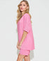Woman wearing a pink outfit on a white background