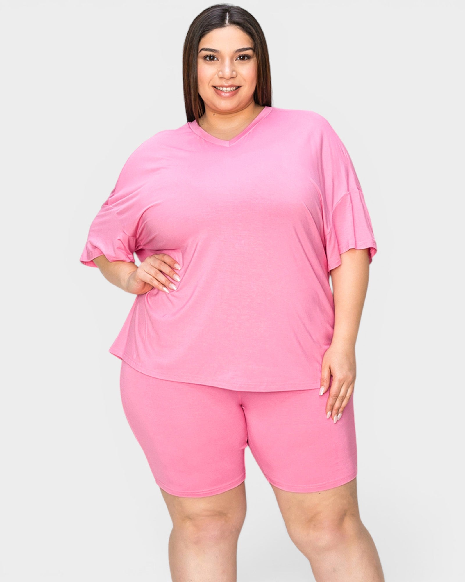 Woman wearing a pink outfit on a white background