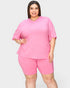 Woman wearing a pink outfit on a white background