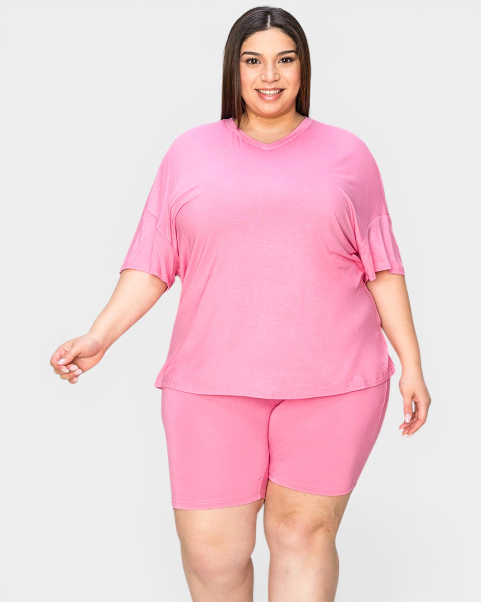 Woman wearing a pink outfit on a white background