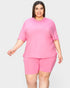 Woman wearing a pink outfit on a white background