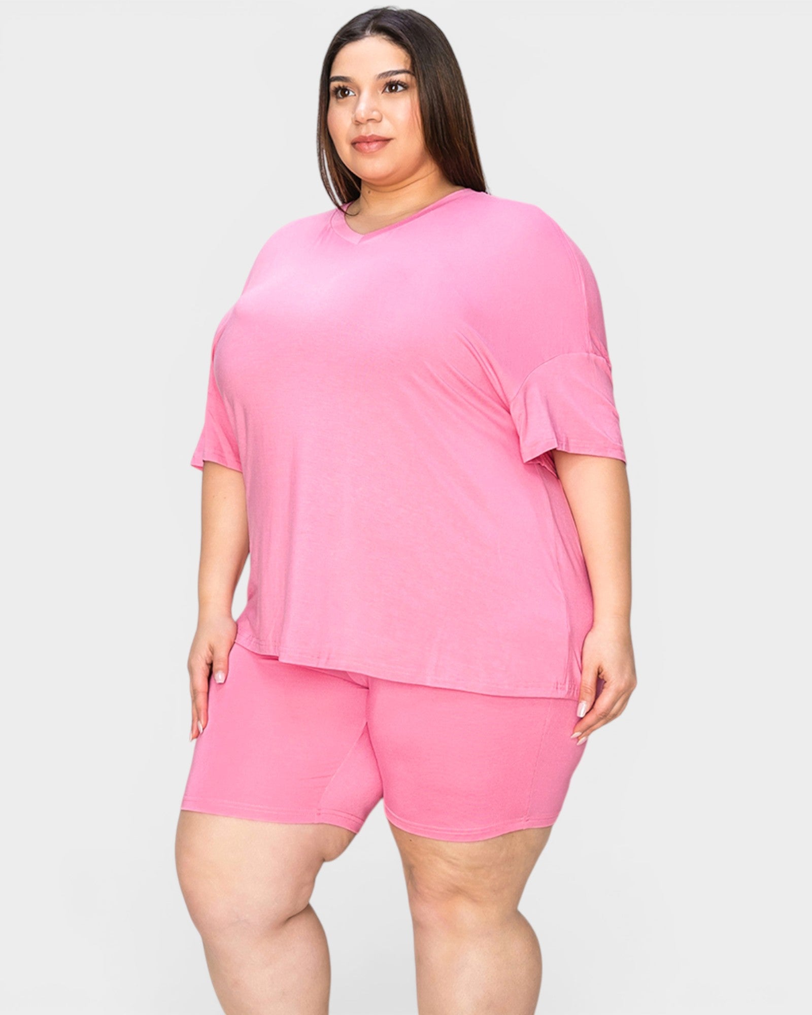 Woman wearing a pink outfit on a white background