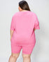 Person wearing a pink outfit on a plain background