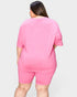 Person wearing a pink outfit on a plain background
