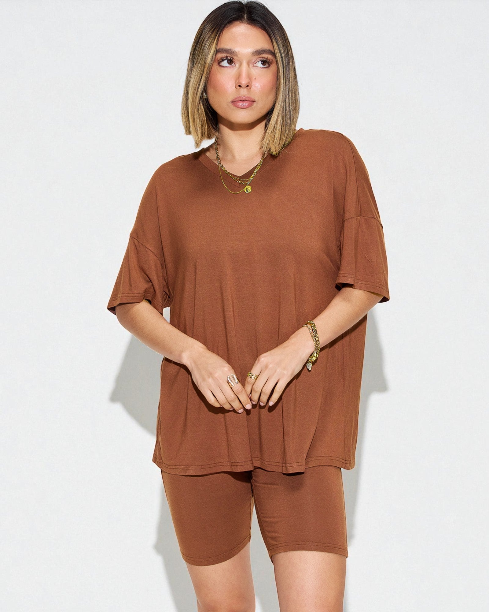 Woman wearing a brown outfit on a white background