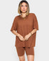 Woman wearing a brown outfit on a white background