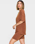 Woman wearing a brown outfit on a white background