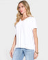 Woman wearing a white t-shirt and blue jeans on a plain background