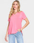 Woman wearing a pink t-shirt and light blue jeans on a white background
