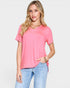 Woman wearing a pink t-shirt and blue jeans on a white background