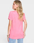 Woman wearing a pink t-shirt on a plain background