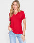 Woman wearing a red t-shirt and light blue jeans on a white background