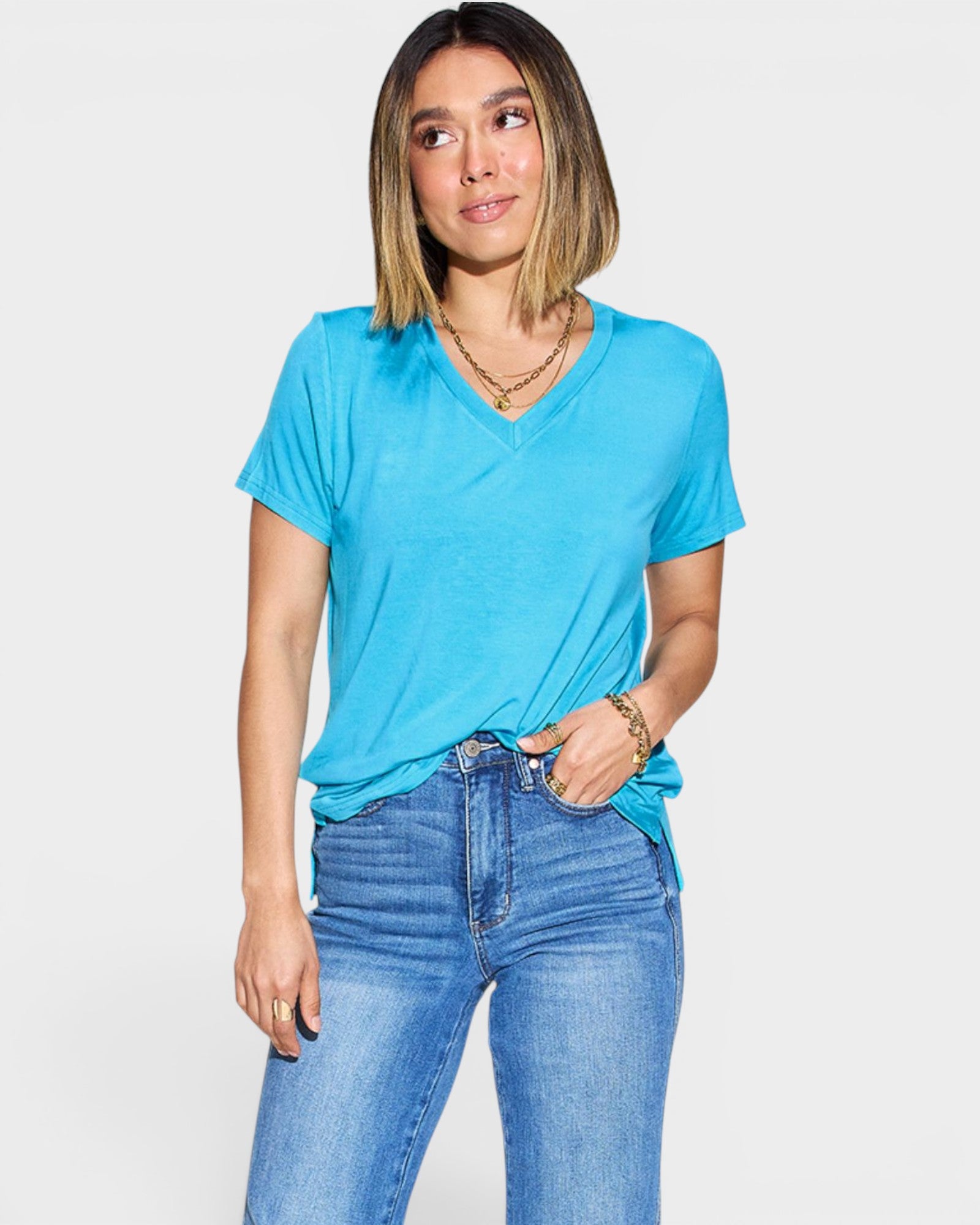 Woman wearing a blue t-shirt and jeans on a white background