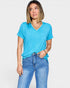 Woman wearing a blue t-shirt and jeans on a white background