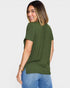 Woman wearing an olive green t-shirt and blue jeans on a white background