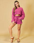 Woman wearing a pink outfit on a beige background