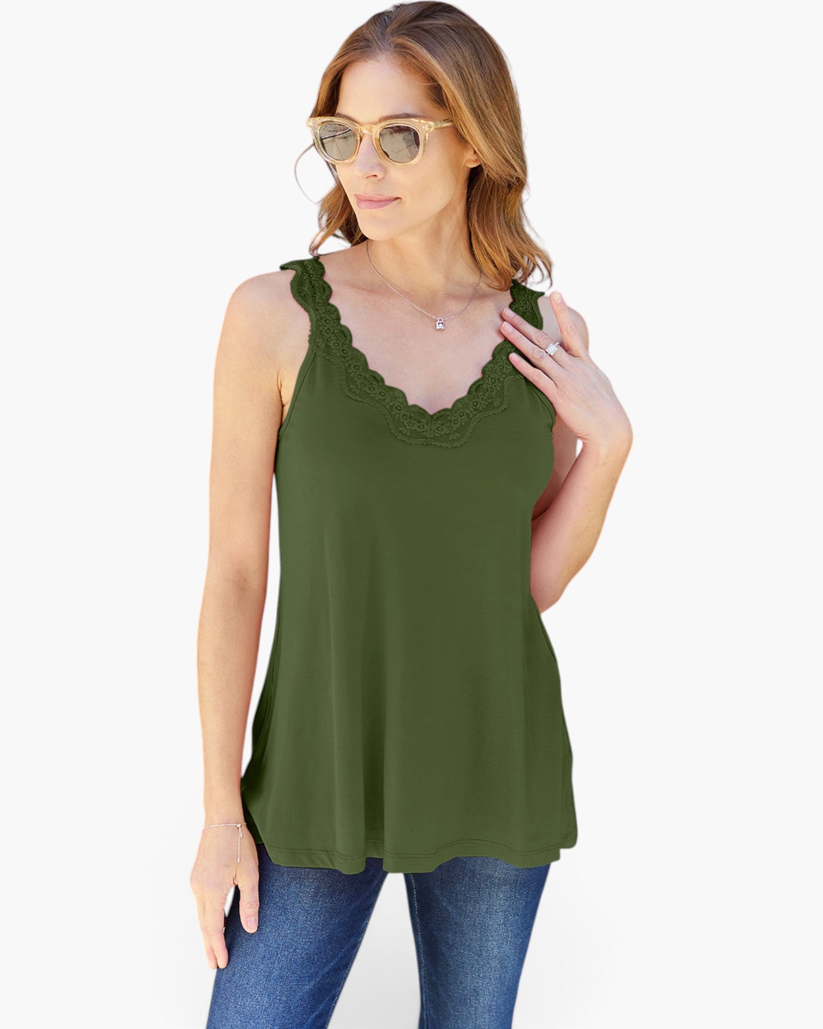 A woman modeling an olive green sleeveless tank top with a scalloped lace V-neckline, paired with blue jeans against a plain white background.