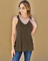 Woman wearing a brown tank top with lace details against a beige background