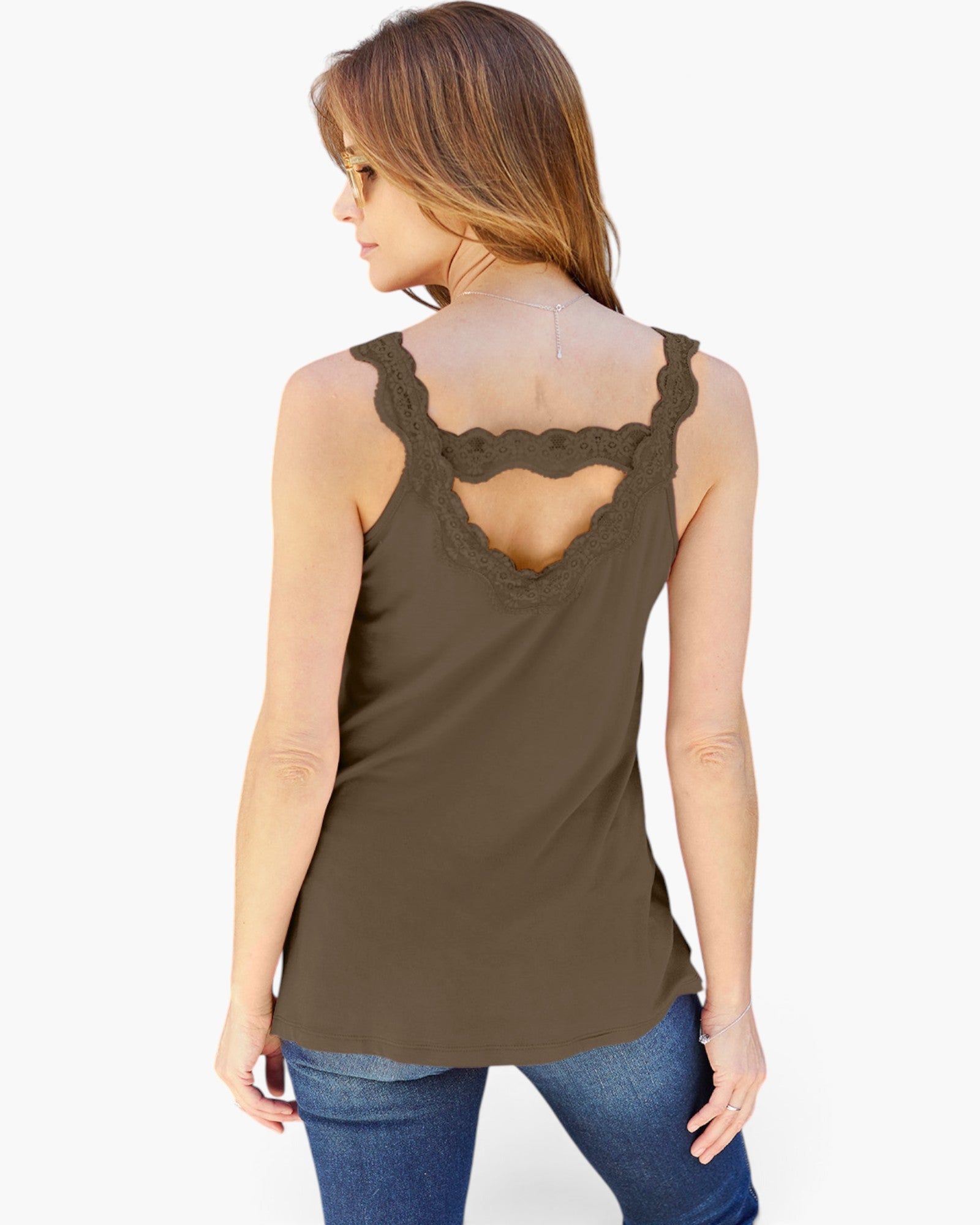 A woman shown from the back wearing a sleeveless olive brown top with a scalloped lace open back, paired with blue jeans, against a plain white background.