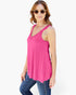 A woman modeling a bright pink sleeveless top with scalloped lace trim at the neckline, paired with blue jeans, against a plain white background.