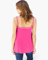 A woman shown from the back wearing a bright pink spaghetti-strap camisole top with a ruffled neckline, paired with blue jeans, against a plain white background.