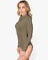 A woman modeling a long-sleeve, mock-neck bodysuit in a solid taupe-brown color, shown from a side profile against a clean white background.