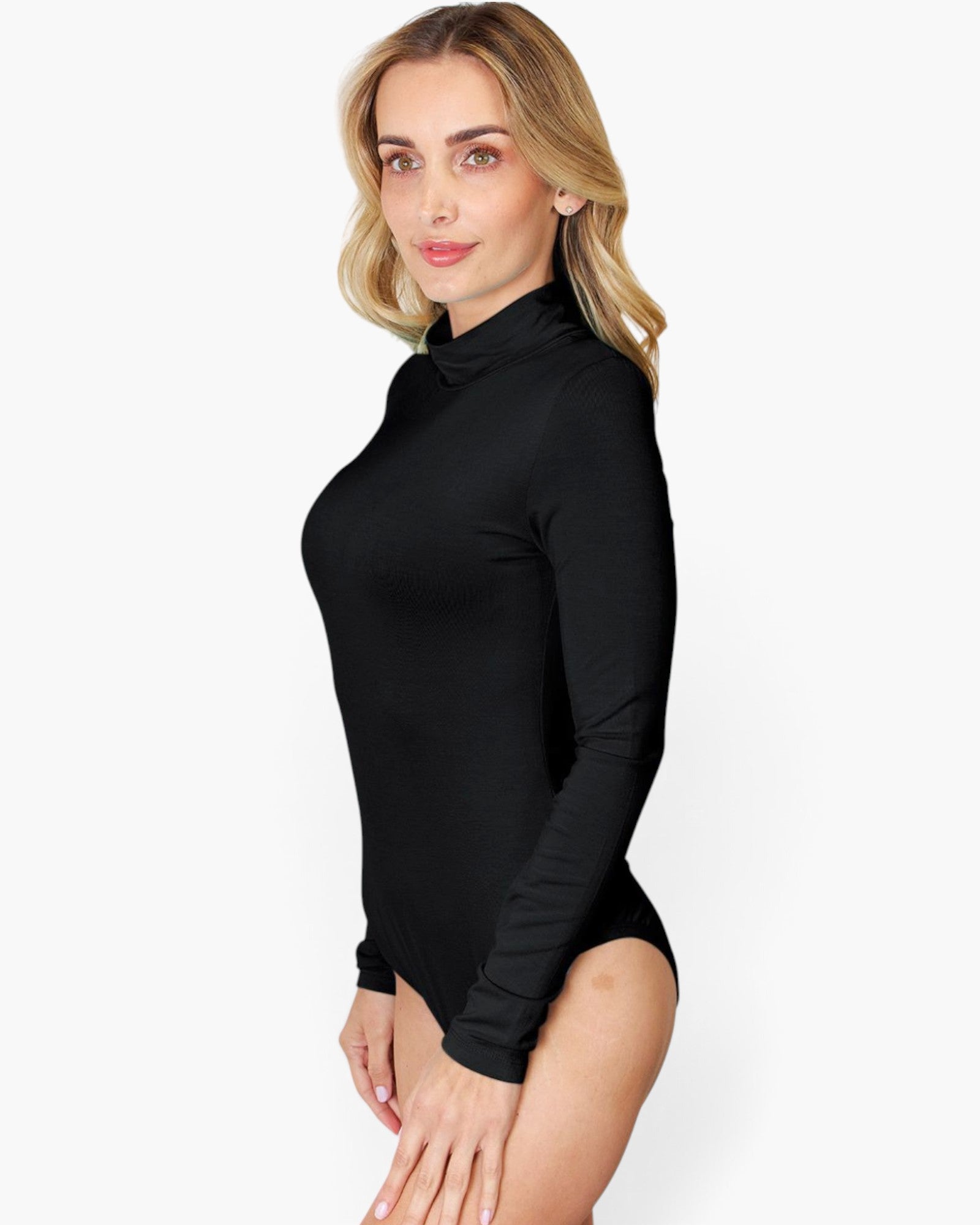 A woman modeling a black long-sleeve mock neck bodysuit against a plain white studio background.