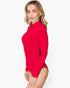 A woman modeling a bright red long-sleeve mock neck bodysuit against a clean white background.