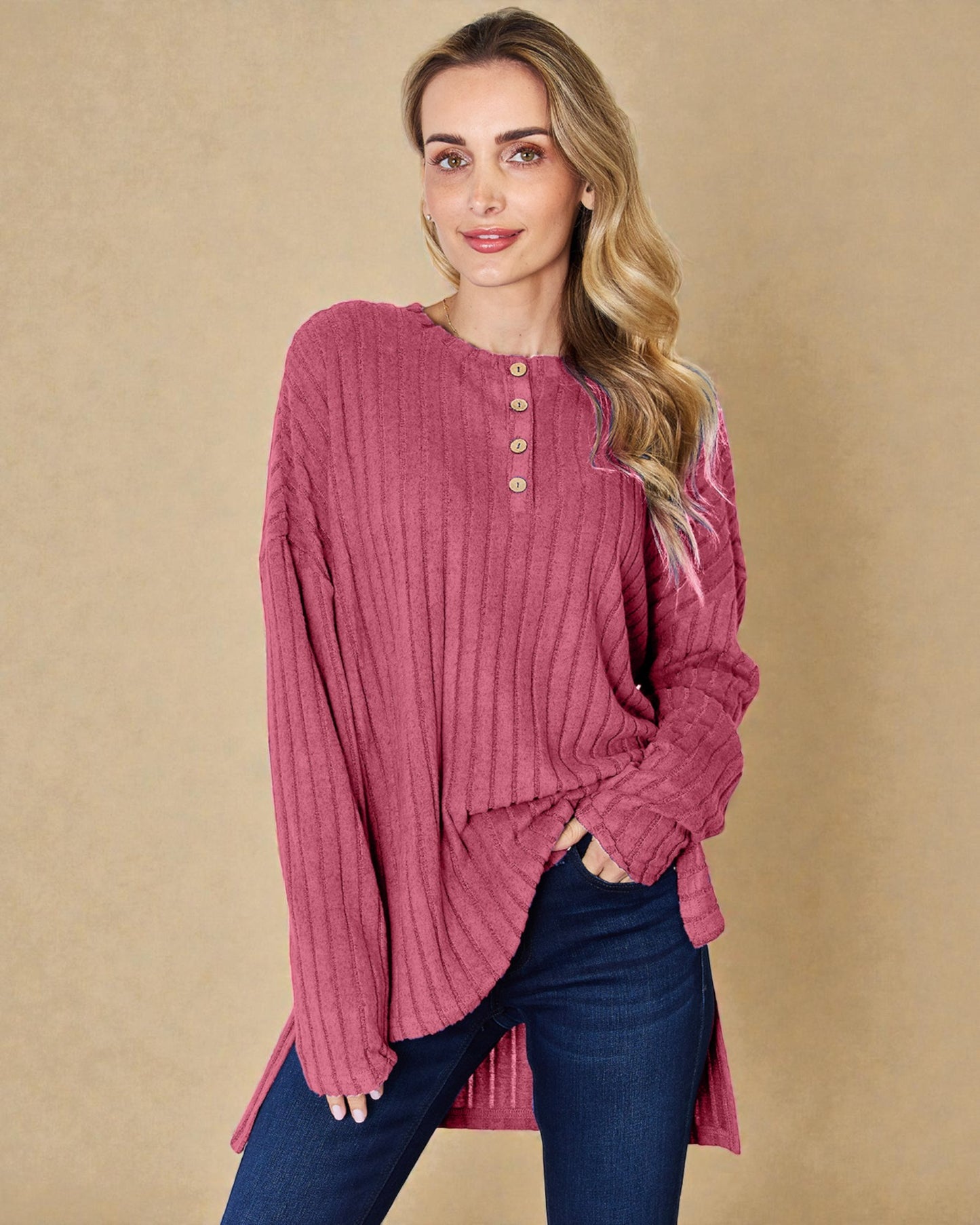 Woman wearing a pink ribbed long-sleeve top against a beige background