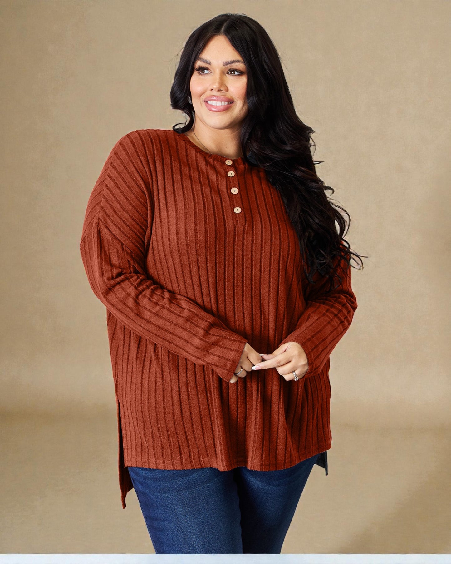 Woman wearing a rust-colored ribbed sweater against a beige background