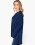 A woman modeling a navy blue ribbed knit long-sleeve top against a plain white studio background.