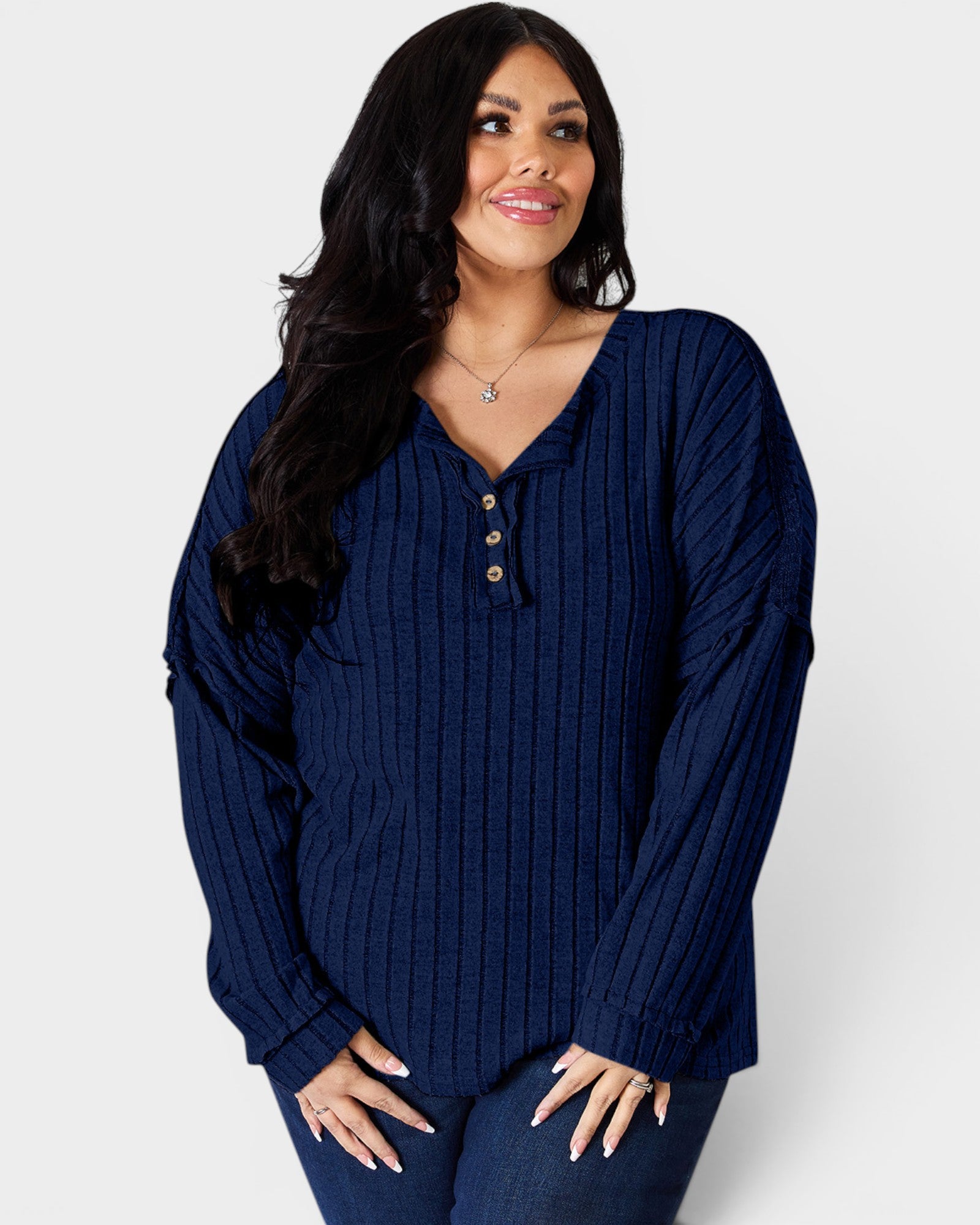 Woman wearing a blue ribbed sweater on a white background