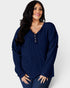 Woman wearing a blue ribbed sweater on a white background