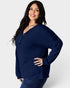 Woman wearing a navy blue ribbed sweater on a white background