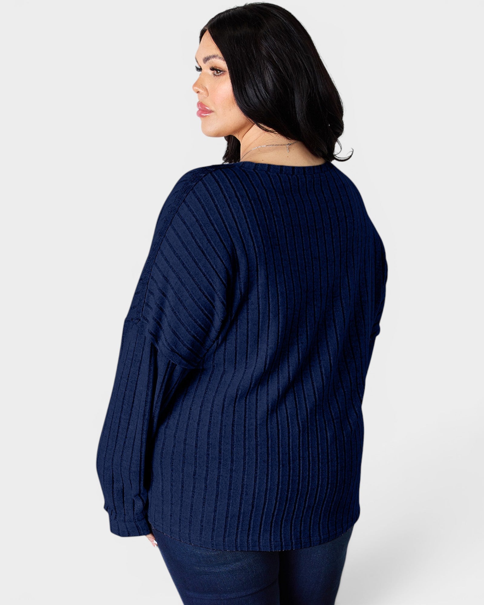Woman wearing a navy blue sweater on a white background