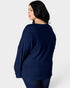 Woman wearing a navy blue sweater on a white background