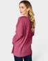 Woman wearing a pink ribbed sweater on a white background
