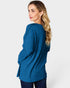 Woman wearing a blue ribbed sweater on a white background