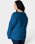 Woman wearing a blue ribbed sweater on a white background