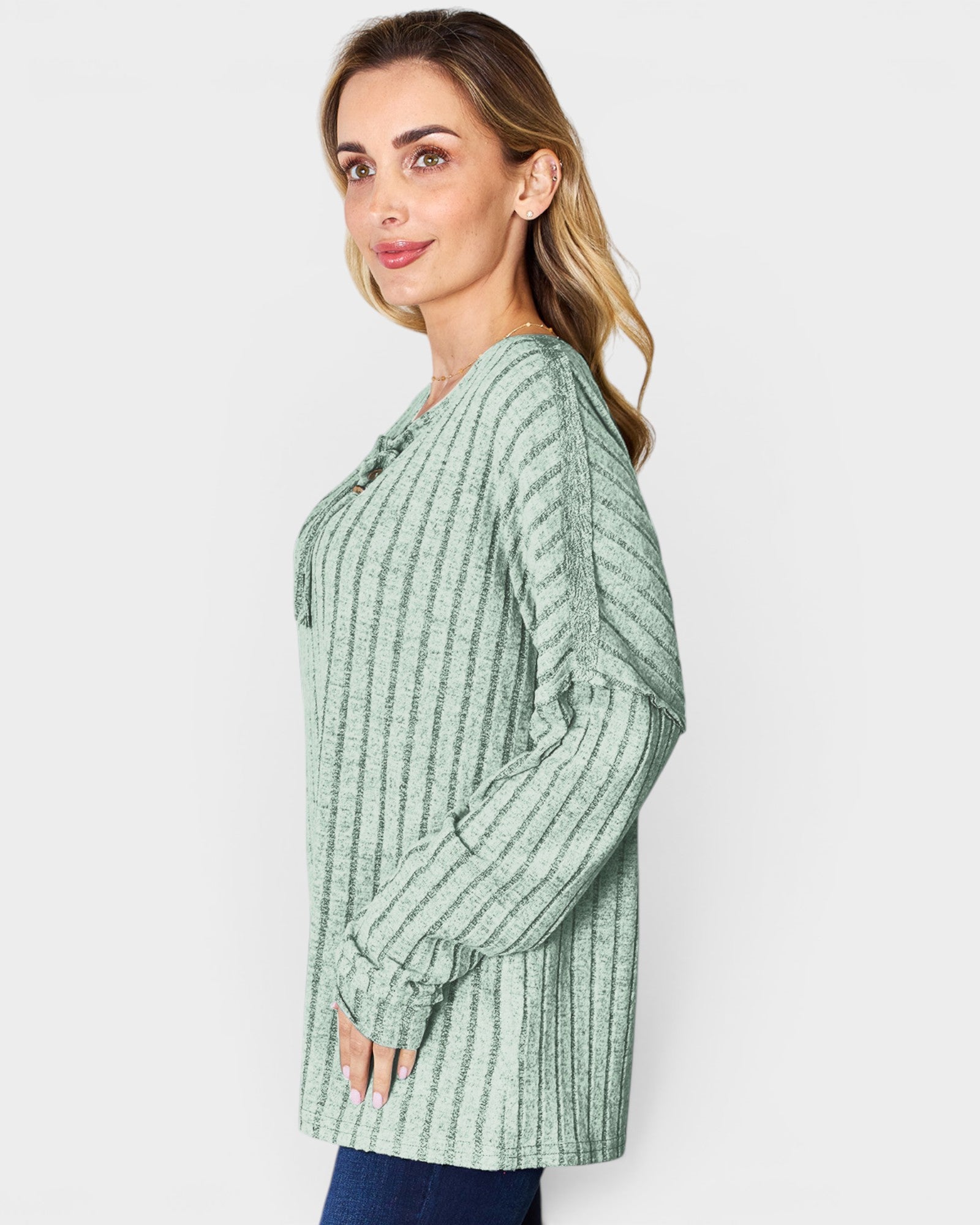 Woman wearing a green striped shirt against a white background