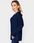 Woman wearing a navy blue ribbed sweater on a white background