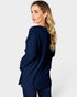 Woman wearing a navy blue ribbed sweater on a white background