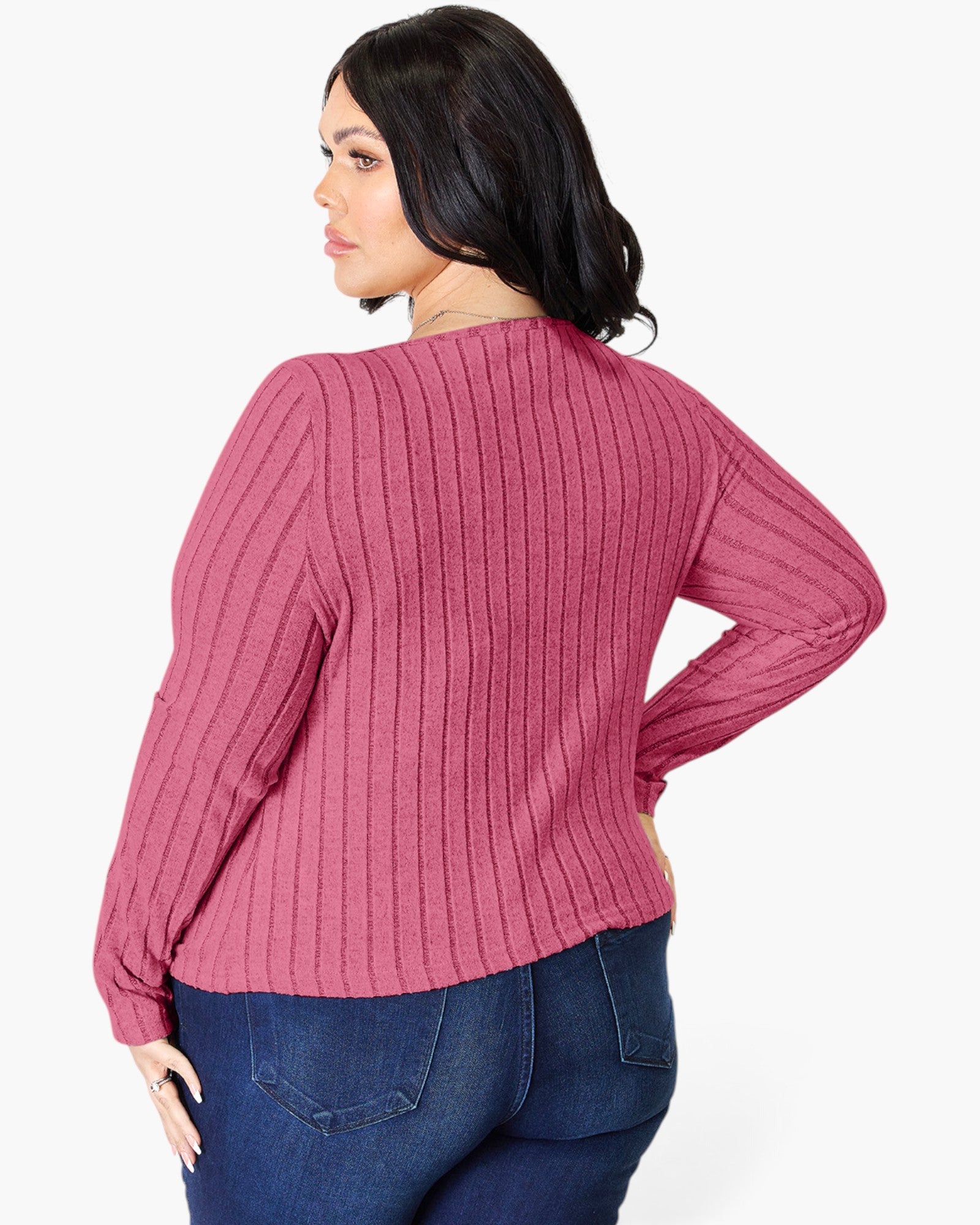 A woman wearing a pink ribbed knit long-sleeve sweater, shown from the back against a plain white background.