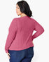 A woman wearing a pink ribbed knit long-sleeve sweater, shown from the back against a plain white background.