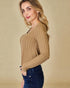 Woman wearing a brown ribbed sweater against a beige background