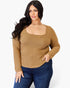 A woman modeling a tan ribbed long-sleeve top with a square neckline, paired with dark blue jeans, against a plain white background.