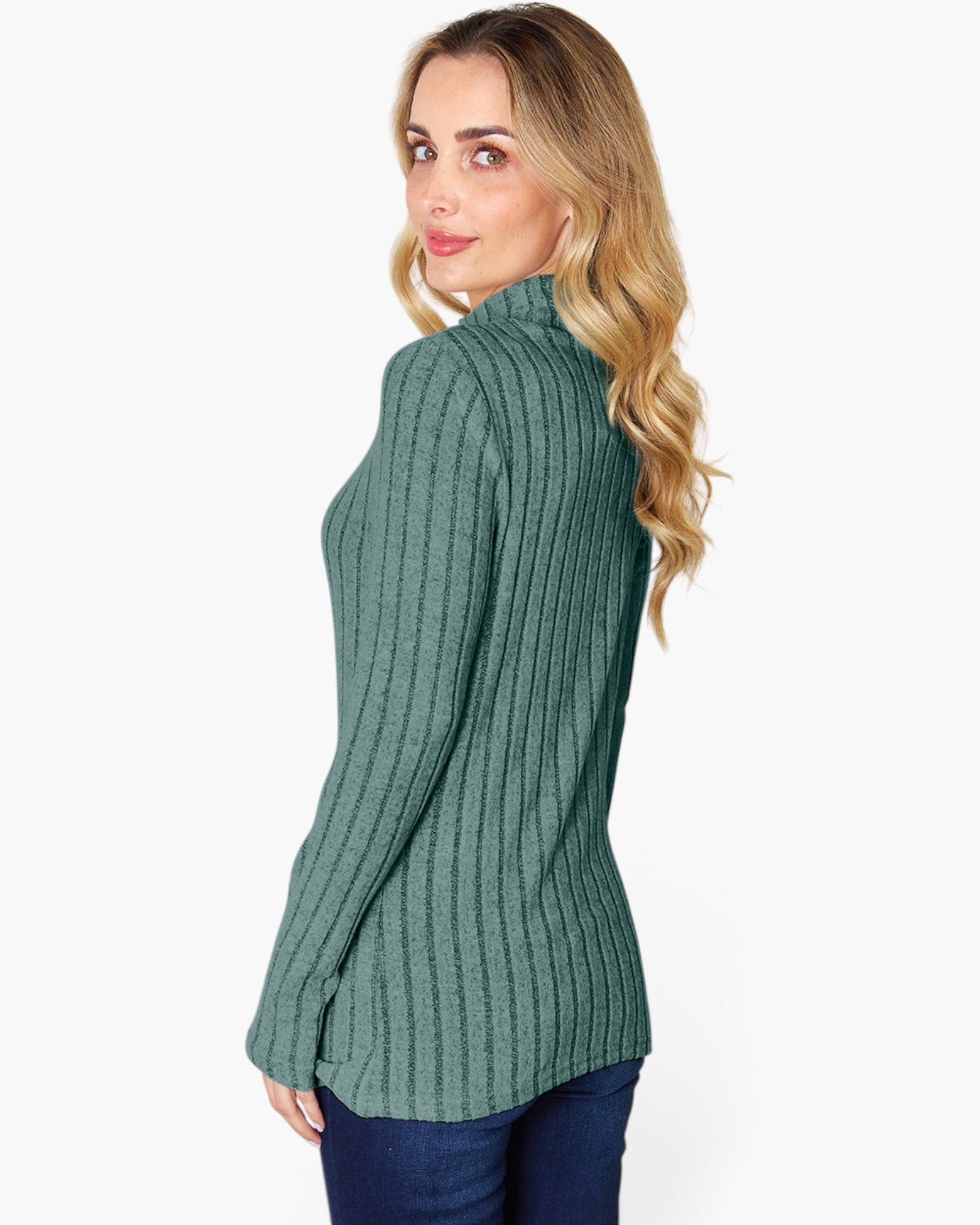 A woman wearing a ribbed green mock neck sweater, shown from a side-back angle against a plain white background.