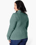 A woman shown from the back wearing a sage green ribbed knit sweater and dark blue jeans against a plain white studio background.