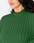Close-up of a woman wearing a ribbed knit mock neck top in forest green.